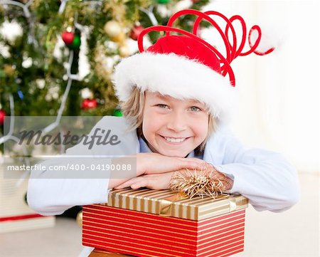 Smiling child opening his present at christmas time