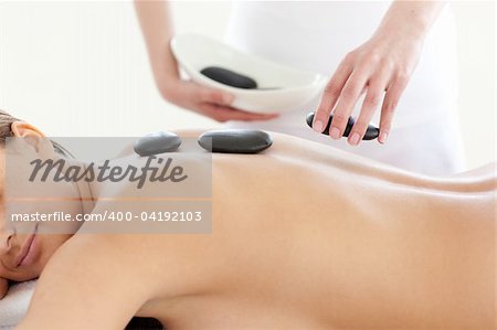 Portrait of a cute woman having a massage with stones at the spa