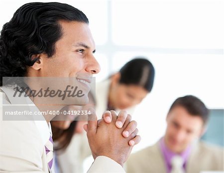 Self-assured businessman in a meeting with his team