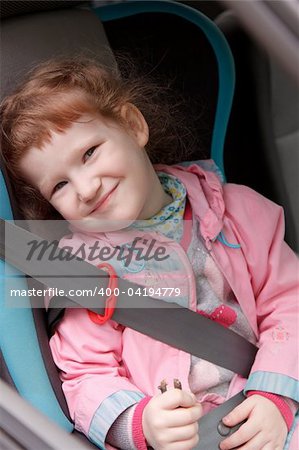 Cute little girl in a baby car seat
