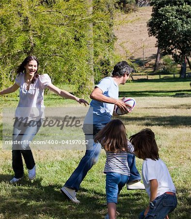 Animated family playing rugby in a park