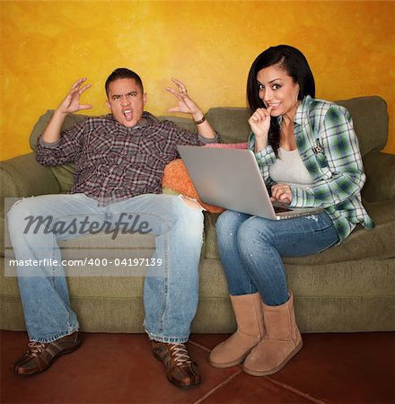 Hispanic Couple on Green Couch with Computer