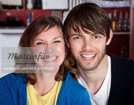 A very happy young hipster couple sitting toether