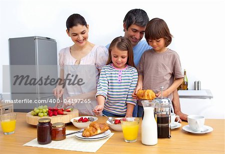 Cheerful family having a breakfast in the kitchen