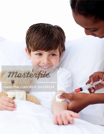 Afro-american female doctor giving a child an injection in a hospital Afro-american female doctor giving a child an injection in a hospital