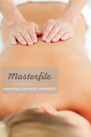Back massage in a health center against a white background