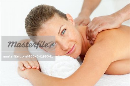Calm woman enjoying a massage in a spa center