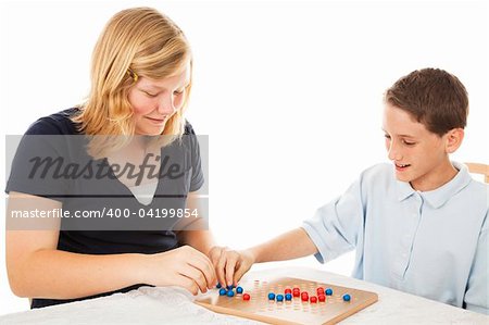 Brother and sister playing a game of chinese checkers (this is a generic game, not a brand name).  White background.