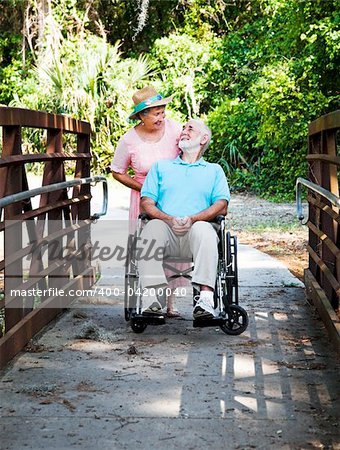 Devoted senior wife cares for her disabled husband.