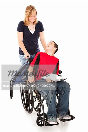 Teen girl pushing her disabled friend in his wheelchair.  Full body isolated.