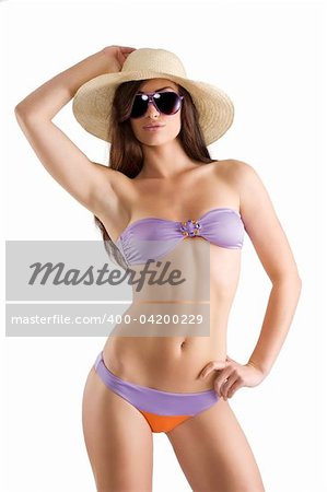 sensual beautiful brunette with long hair wearing a bikini swimsuit hat and sunglasses isolated on white