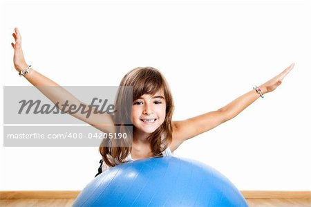 Happy little child playing with a big blue ball