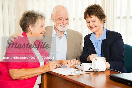 Senior couple gets good financial news from their accountant.