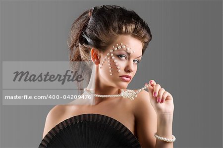 young naked woman with hair style and beautiful fashion make up covering brest with a black fun