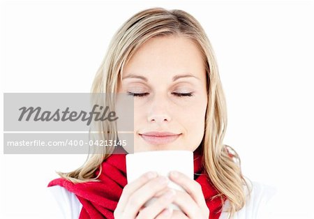 Portrait of a young woman enjoying her hot coffee in the winter against white background