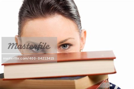 pretty student with big glasses playing and hiding her face behind a pile of book