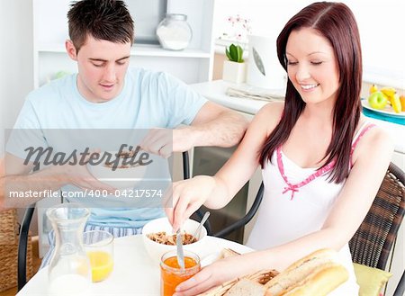 Caucasian couple having breakfast in the kitchen at home