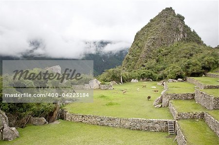 Machu Picchu is a pre-Columbian Inca site located 2,430 metres (8,000 ft) above sea level. It is situated on a mountain ridge above the Urubamba Valley in Peru, which is 80 kilometres (50 mi) northwest of Cusco and through which the Urubamba River flows. The river is a partially navigable headwater of the Amazon River. Often referred to as "The Lost City of the Incas", Machu Picchu is one of the m