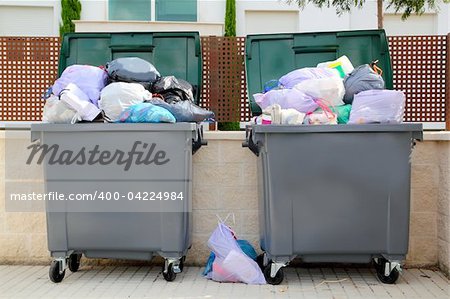 Trash garbage full of bags container in street