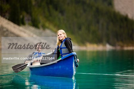 A portrait of a happy woman on a canoeing trip with a man