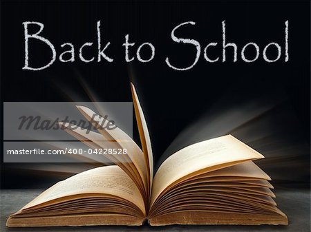 back to school on Black board and book on table