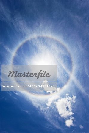 Sun with circular rainbow - sun halo occurring due to ice crystals in atmosphere