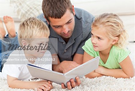 Father reading book to his children