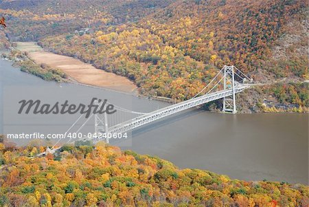Bear Mountain bridge aerial view in Autumn with colorful trees in forest over Hudson River in New York State.