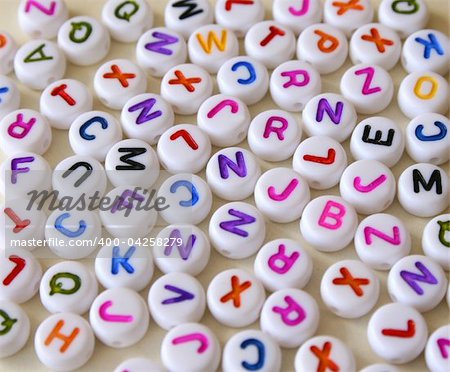 Small Colorful letters on different white shapes