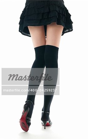 view of the lower body part isolated on white background of woman wearing skirt, stockings and high heels