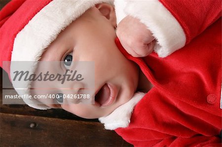 Cute 6 week old baby boy wearing a christmas suit