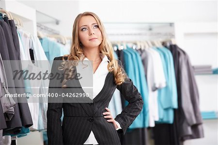 The beautiful young girl in clothes shop