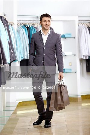 The young man with a bag in shop