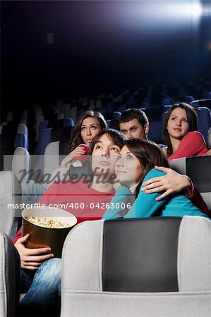 Enamoured couple at cinema in the foreground