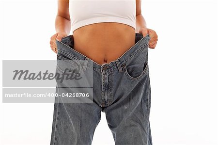 Young woman showing off weight loss with jeans