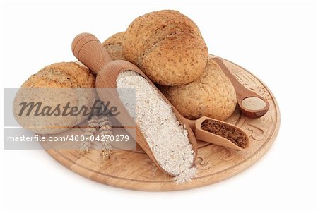 Bread roll selection on a wooden board with wholegrain flour, brown sugar and yeast in scoops, with ears of wheat, over white background..