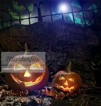 Halloween pumpkins on rocks in a forest at night