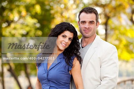A portrait of a happy male and female in a park