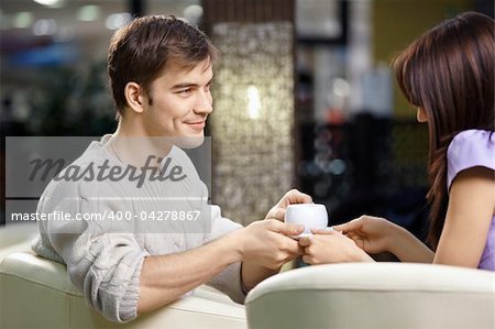 Happy smiling pair of the enamoured have dinner in cafe