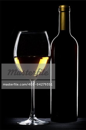 White wine bottle and glass silhouette over black background