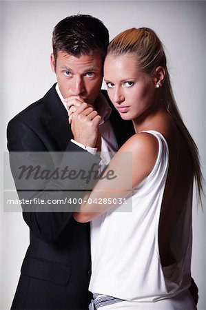 Attractive young couple. Studio portrait on grey background.