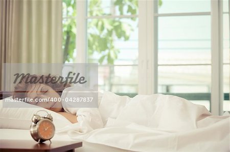 portrait of nice young woman sleeping in her bedroom