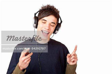 Male Teenager with headphones listening to music and sings happy. Isolated on white background.