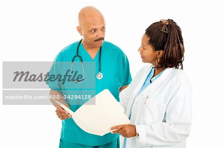 Attractive african-american medical doctors read a patient's chart.  Isolated on white.
