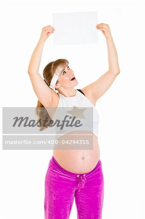 Surprised beautiful pregnant woman holding empty white  paper over her head isolated on white