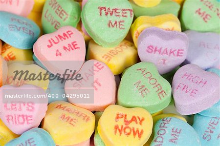 Heart shaped candy with sayings on it. Horizontal shot.