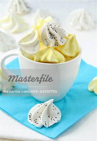 colorful meringue beze cookies in a cup on the table