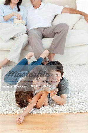 Family watching tv in the living room at home