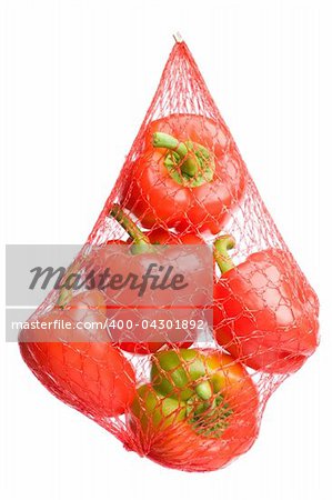 red bell peppers hanging in plastic net