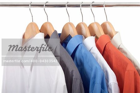 clothes hanger with shirts isolated on white